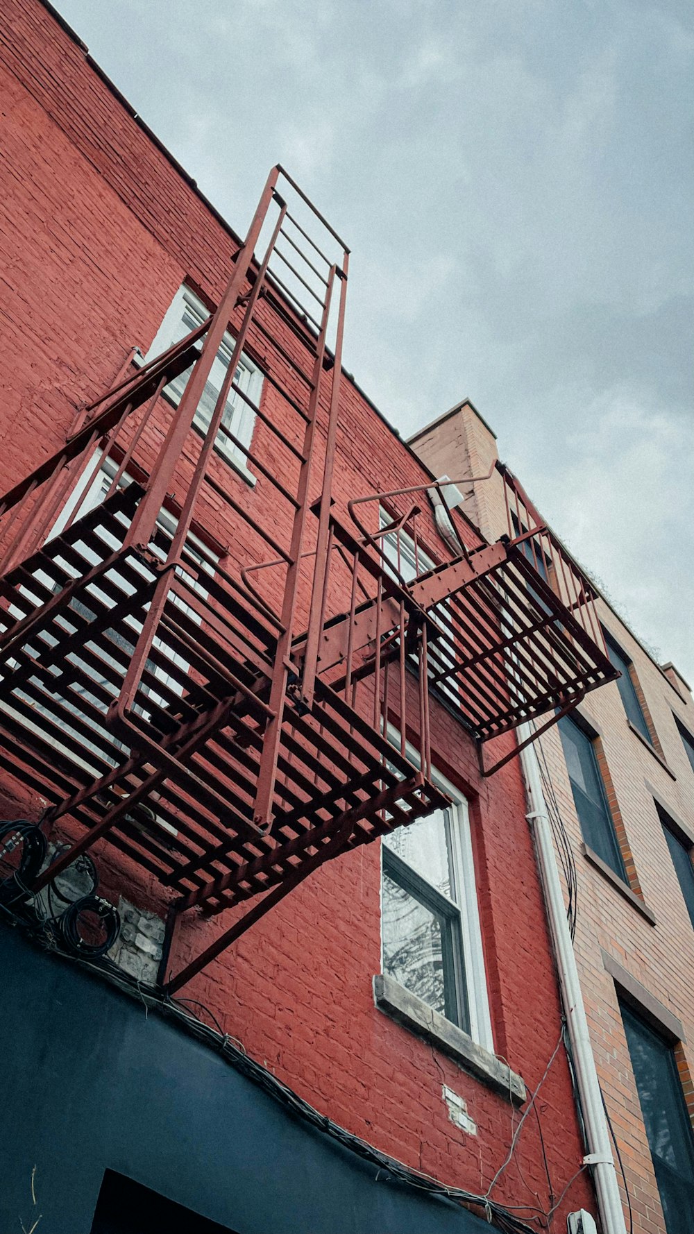 a red brick building with a ladder attached to it