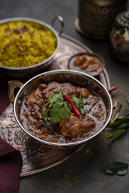 a bowl of food on a table with other dishes