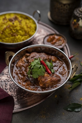 a bowl of food on a table with other dishes
