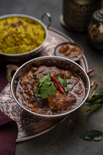 a bowl of food on a table with other dishes