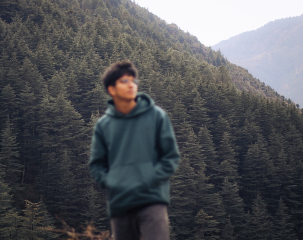 a man standing in front of a mountain