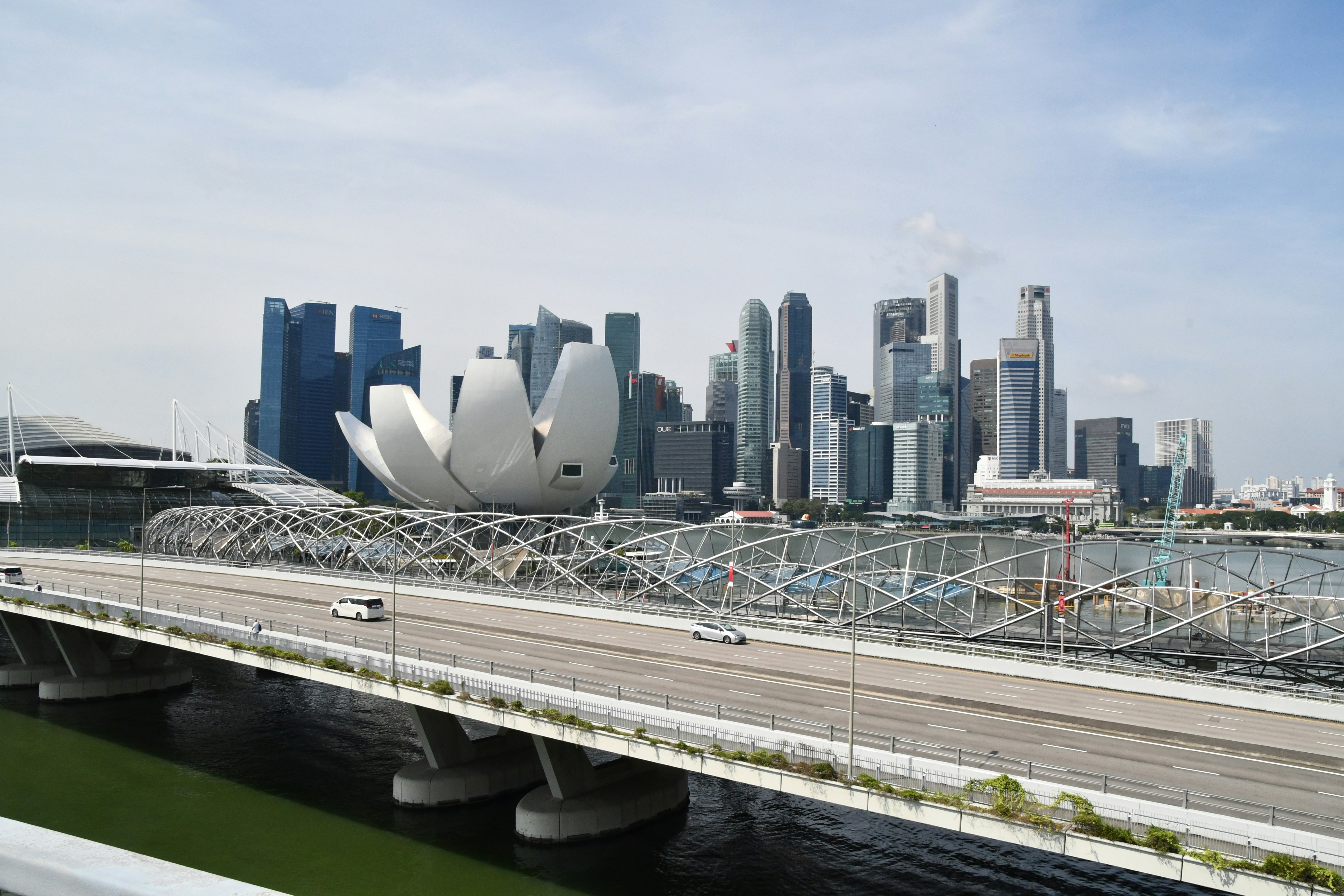 a bridge over a river with a city in the background