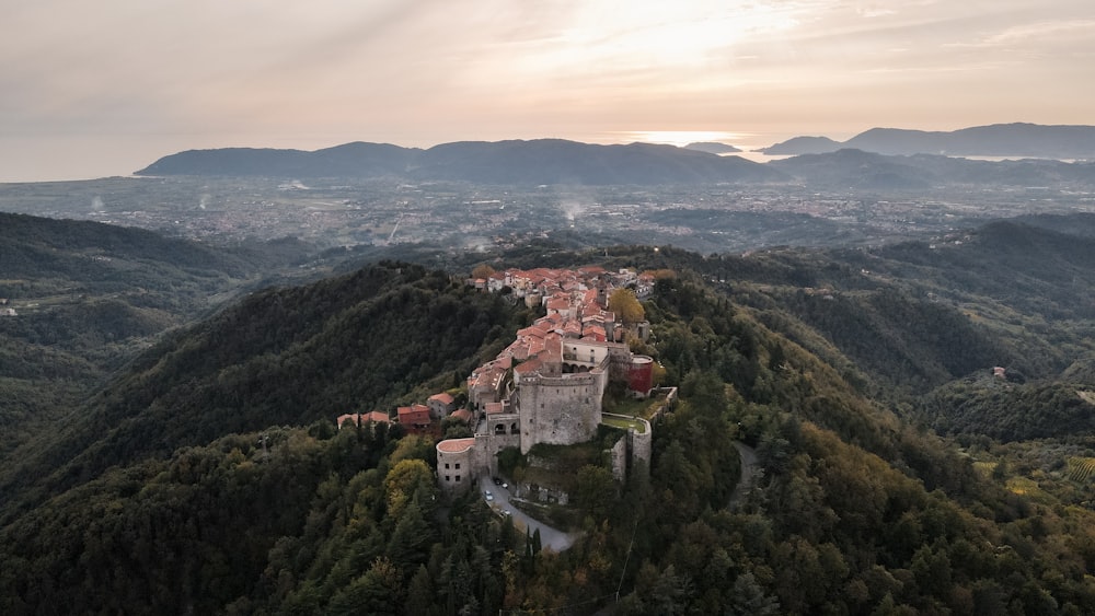 an aerial view of a castle in the mountains