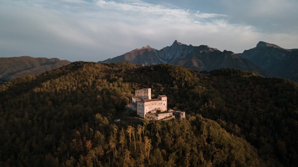 a castle perched on top of a lush green hillside