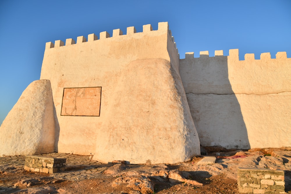 a stone wall with a gate on top of it