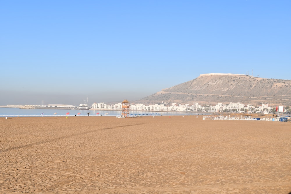 a beach with a mountain in the background