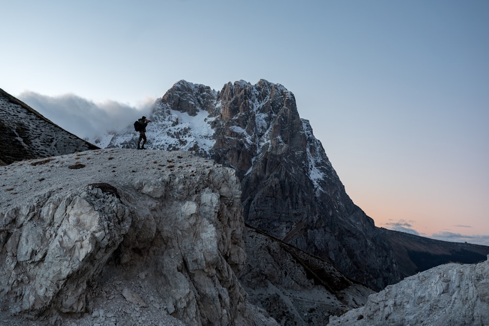 a man standing on top of a snow covered mountain