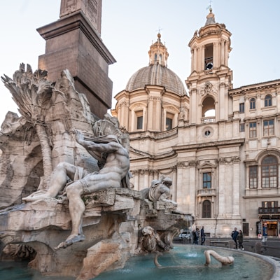 a large building with a fountain in front of it
