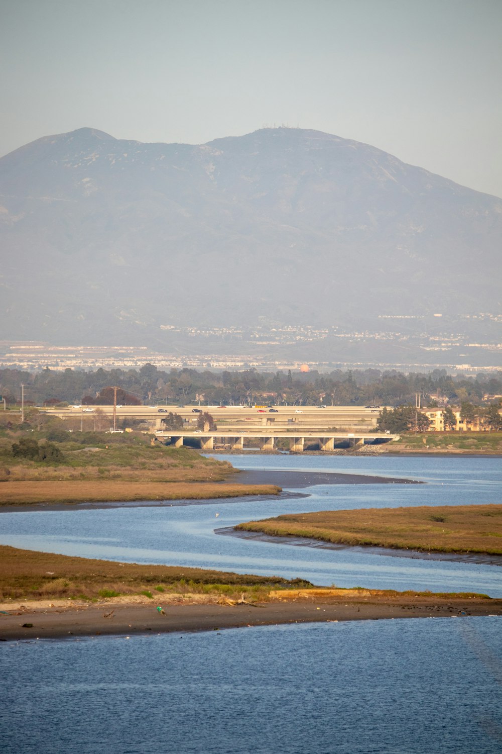 a body of water with a mountain in the background