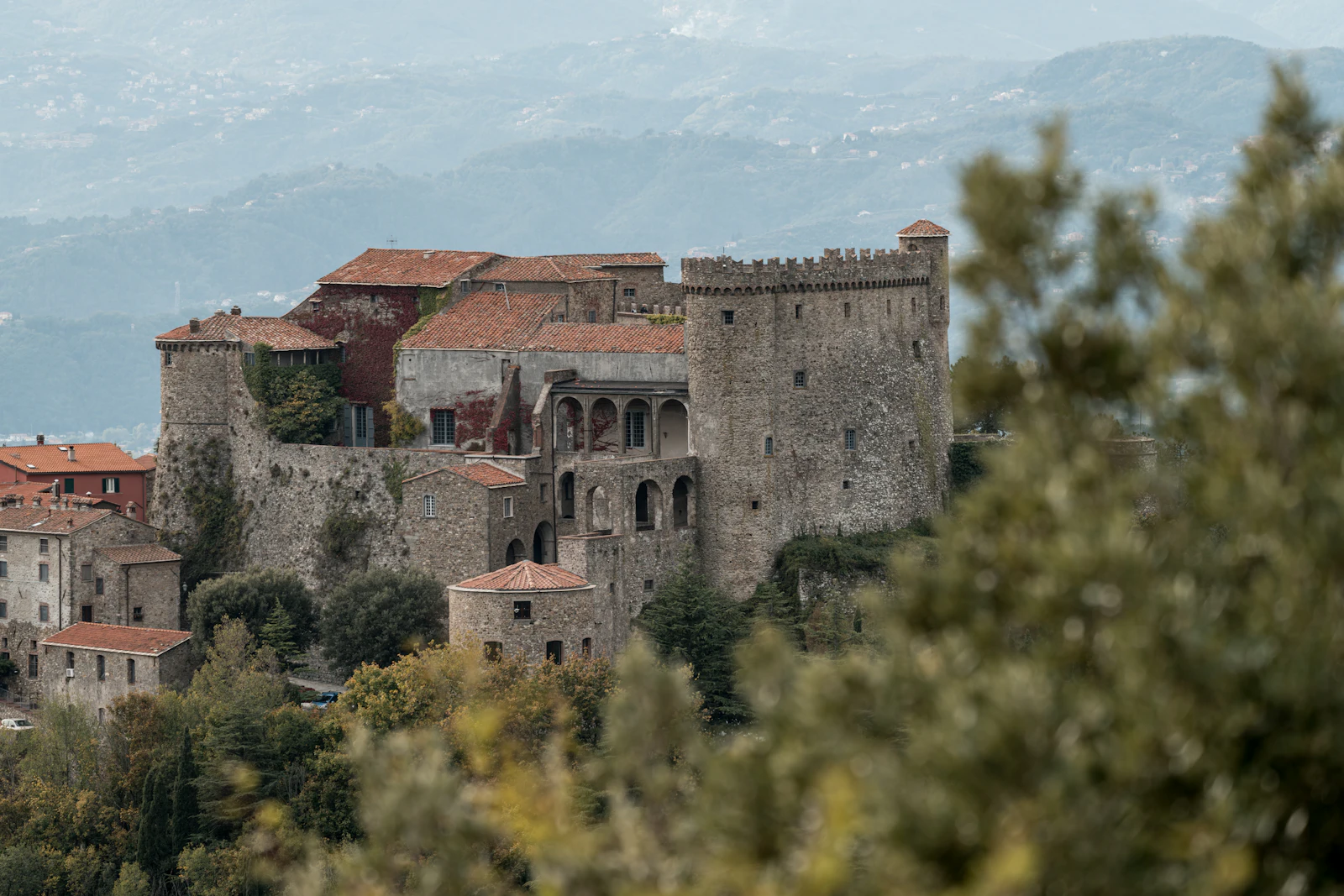Old castle on a wooded hill in the Lunigiana countryside