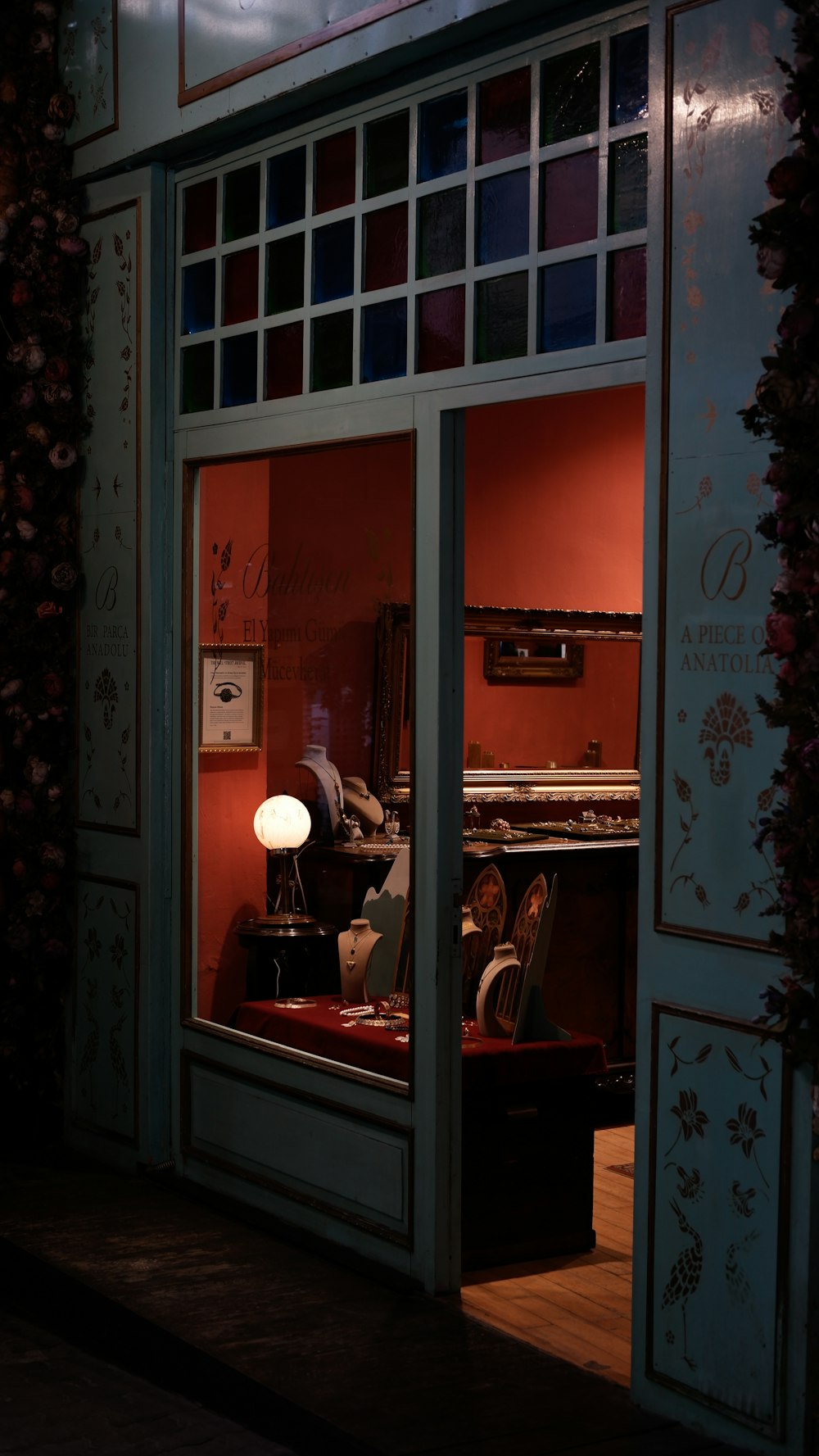 a store front with a lit up window at night