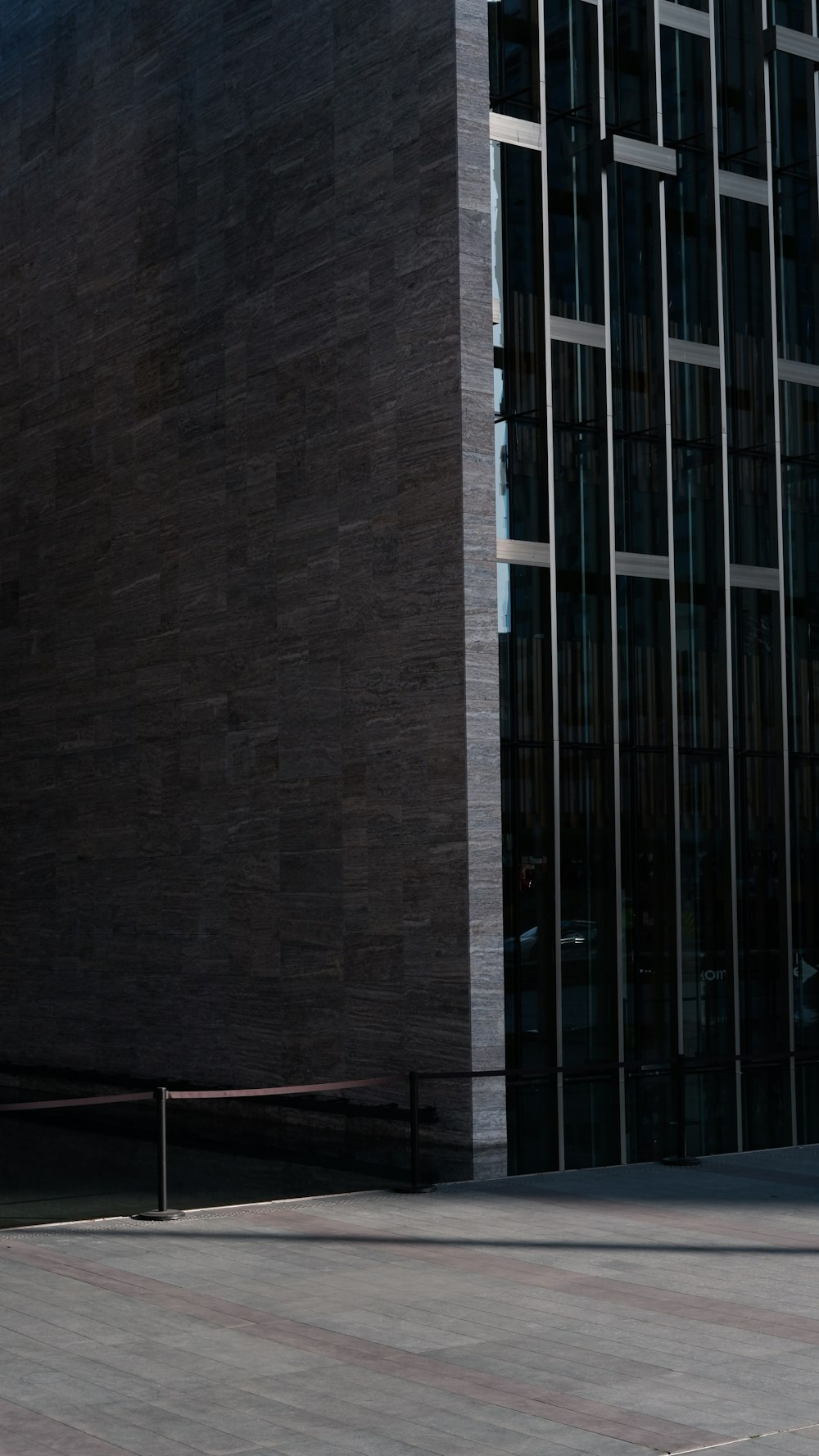 a man riding a skateboard down a street next to a tall building