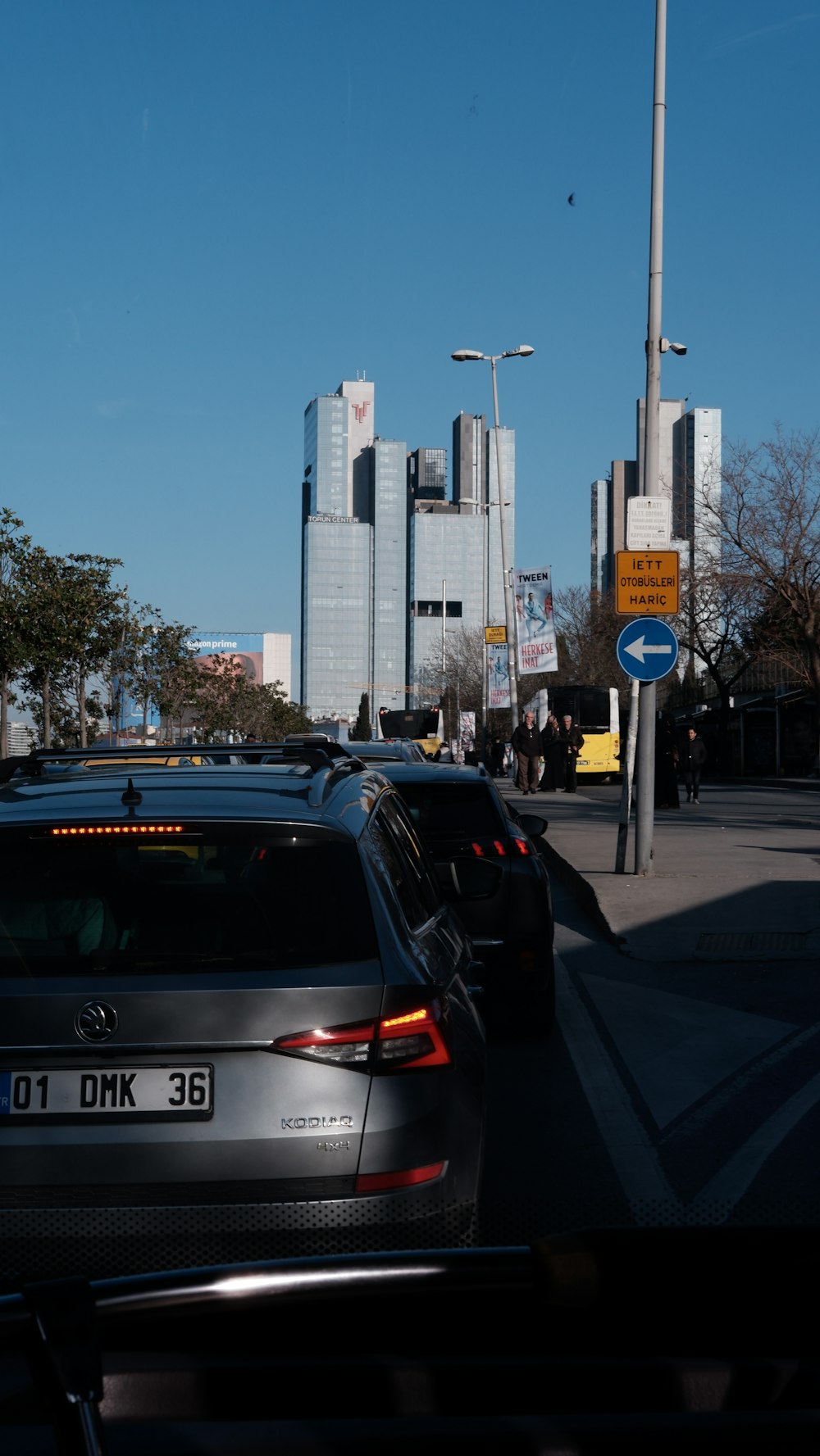 a city street filled with lots of traffic next to tall buildings