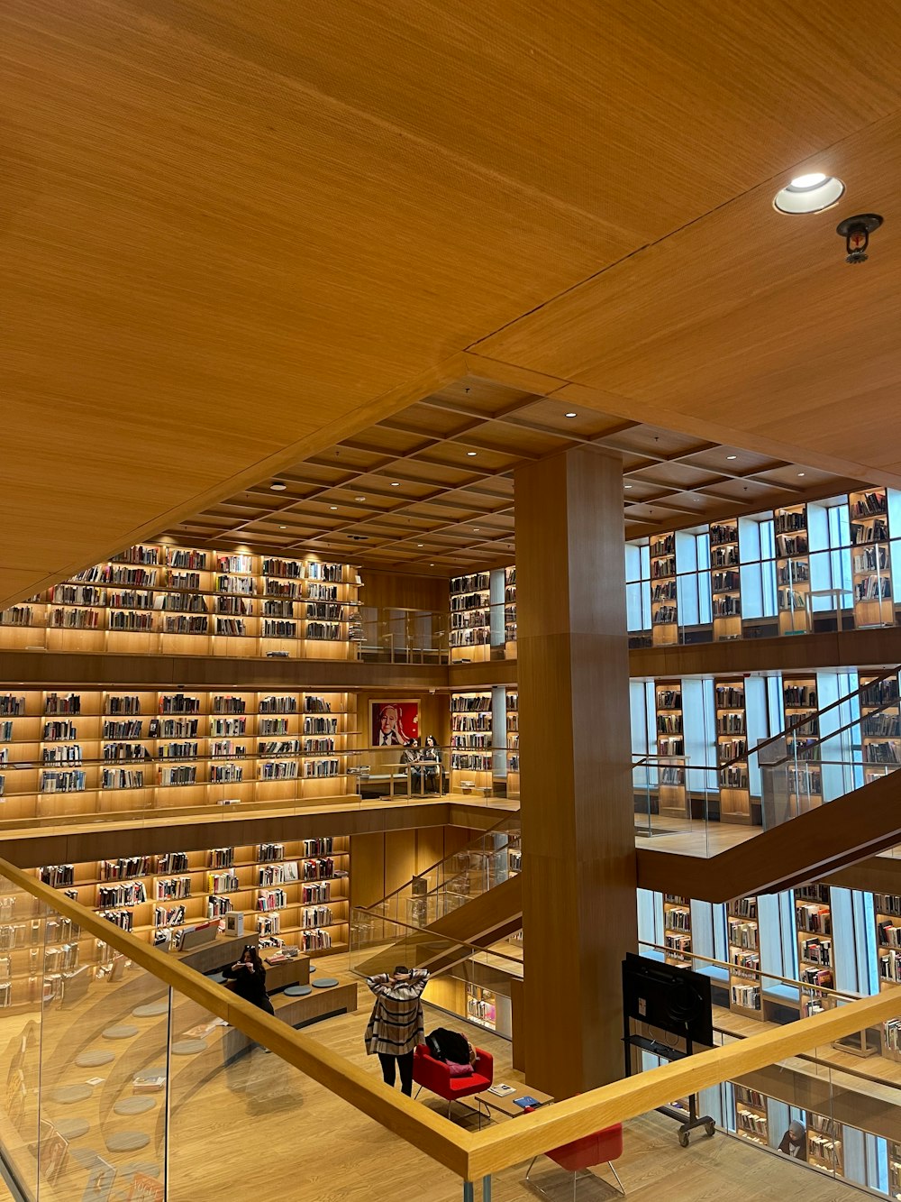 a library filled with lots of books next to a staircase