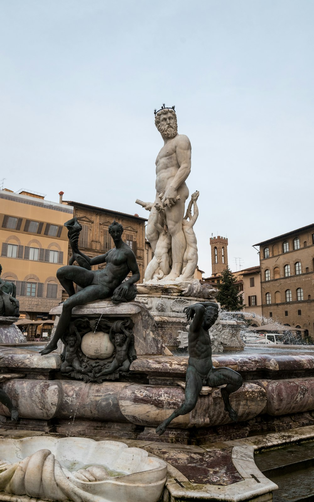 a fountain with statues of men and women on it