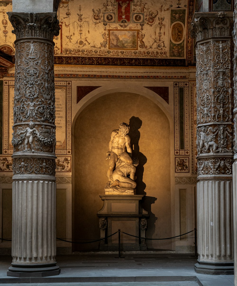 a statue of a man holding a woman in a room