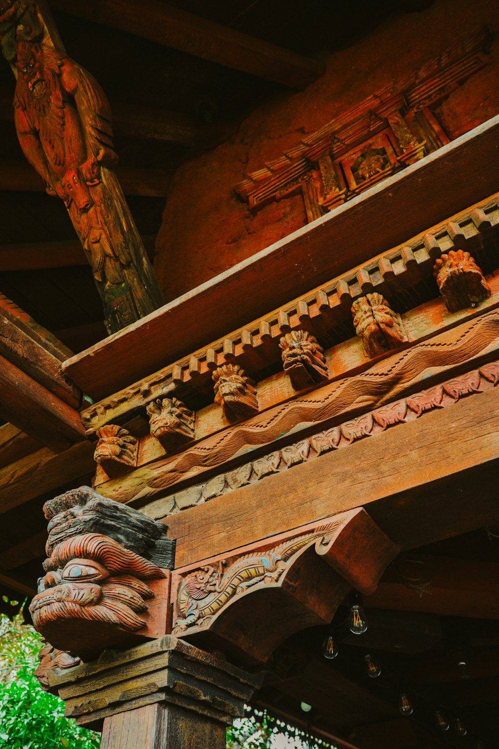 a close up of a wooden structure with carvings on it