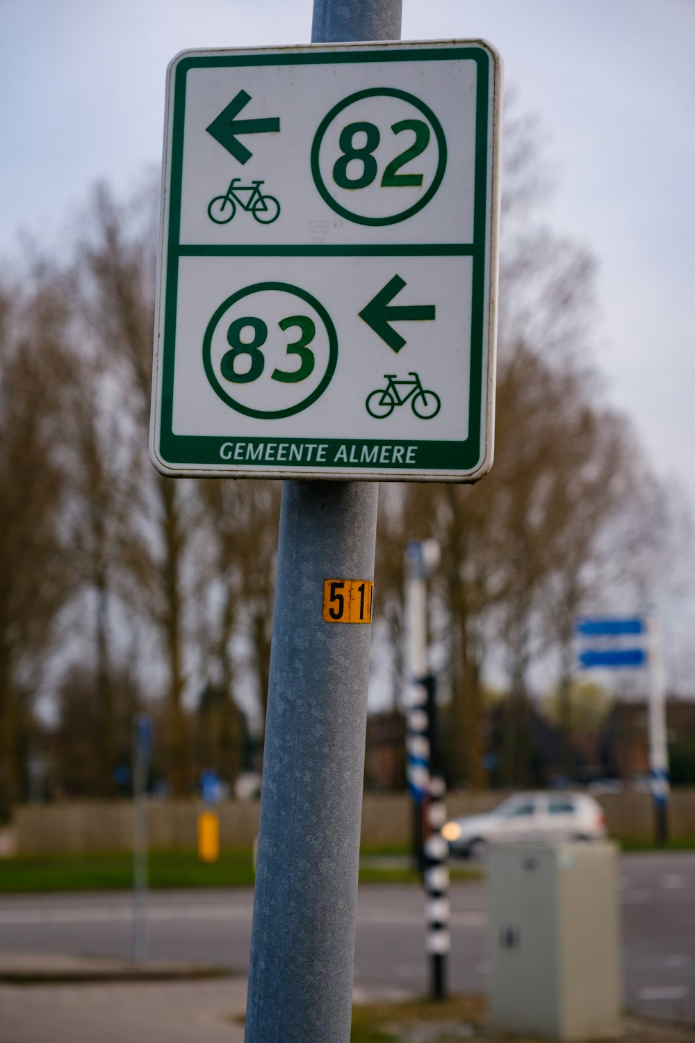 a speed limit sign on a pole on the side of the road