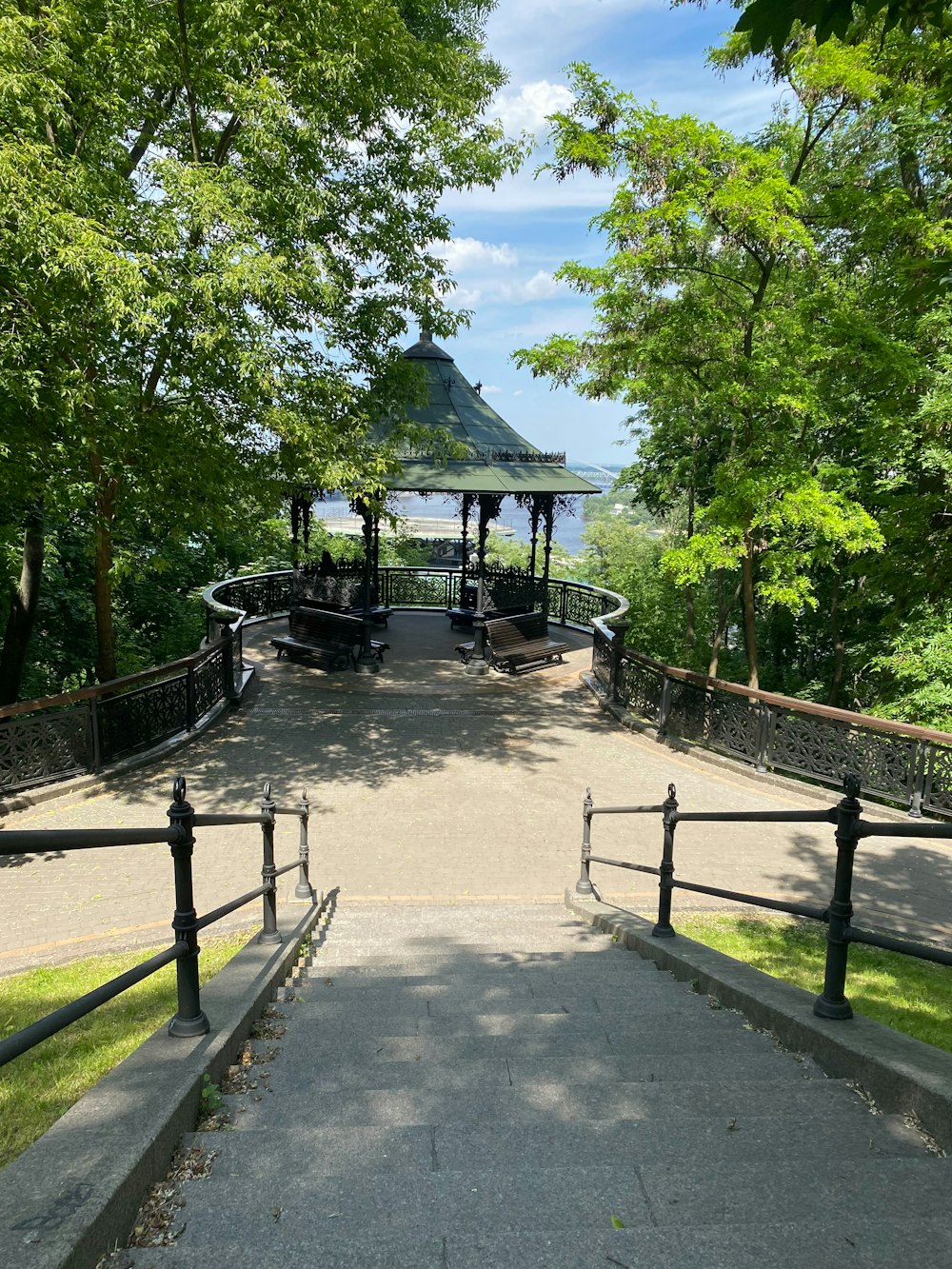 a walkway leading to a gazebo in a park