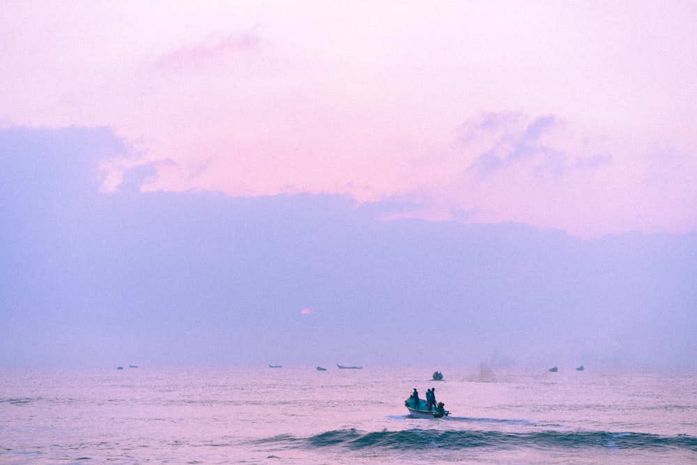 a group of people on a small boat in the ocean