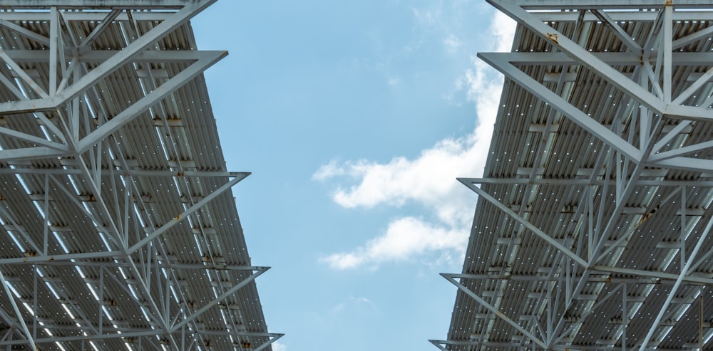 a couple of tall metal structures under a blue sky