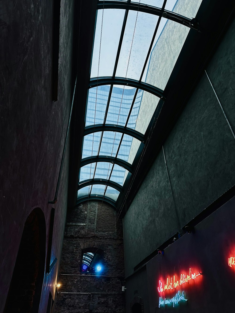 a building with a skylight and neon signs