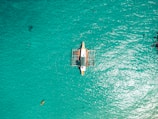 a small boat floating on top of a body of water