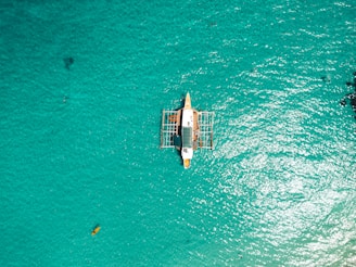 a small boat floating on top of a body of water
