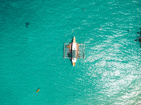 a small boat floating on top of a body of water