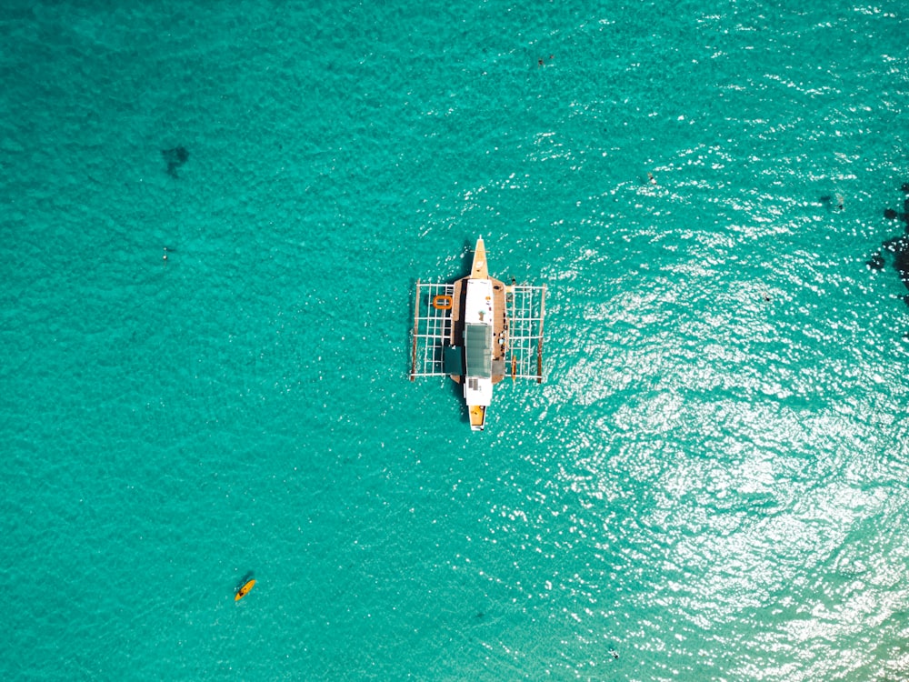 a small boat floating on top of a body of water