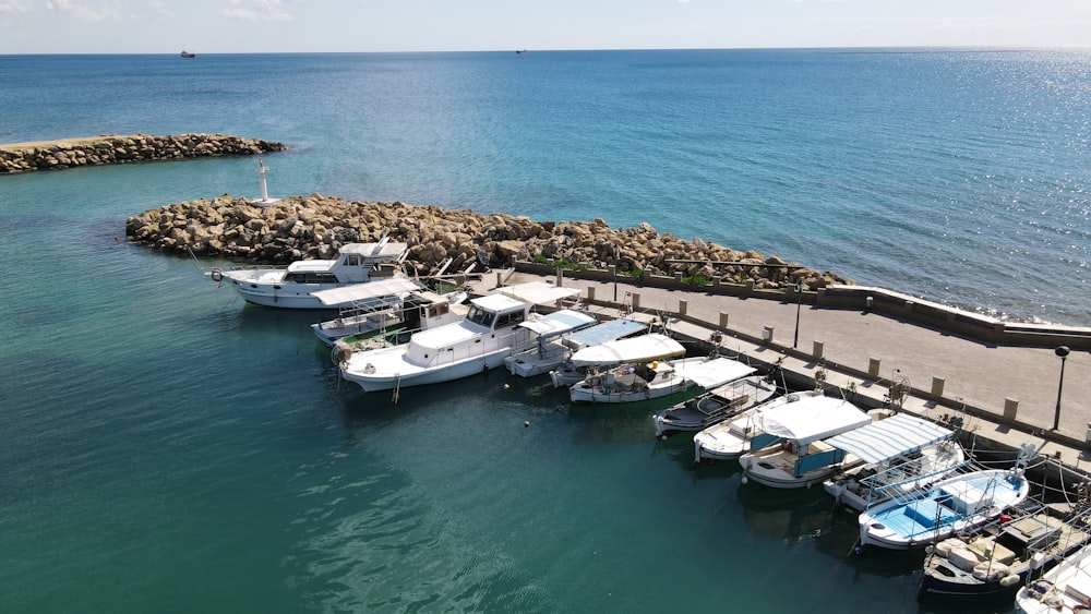 a group of boats parked next to a pier