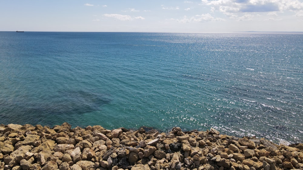 a view of the ocean from a rocky shore