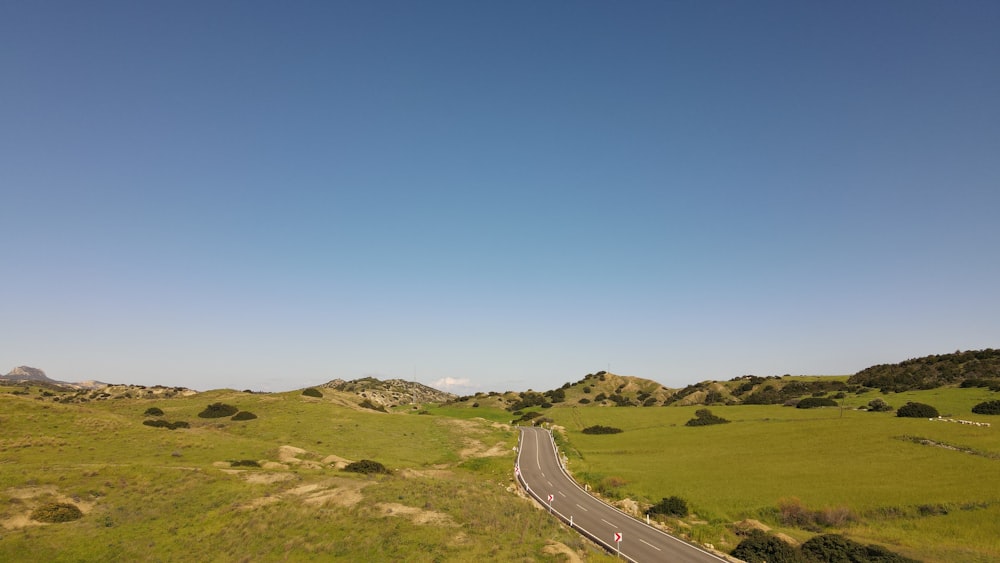 a road going through a lush green countryside