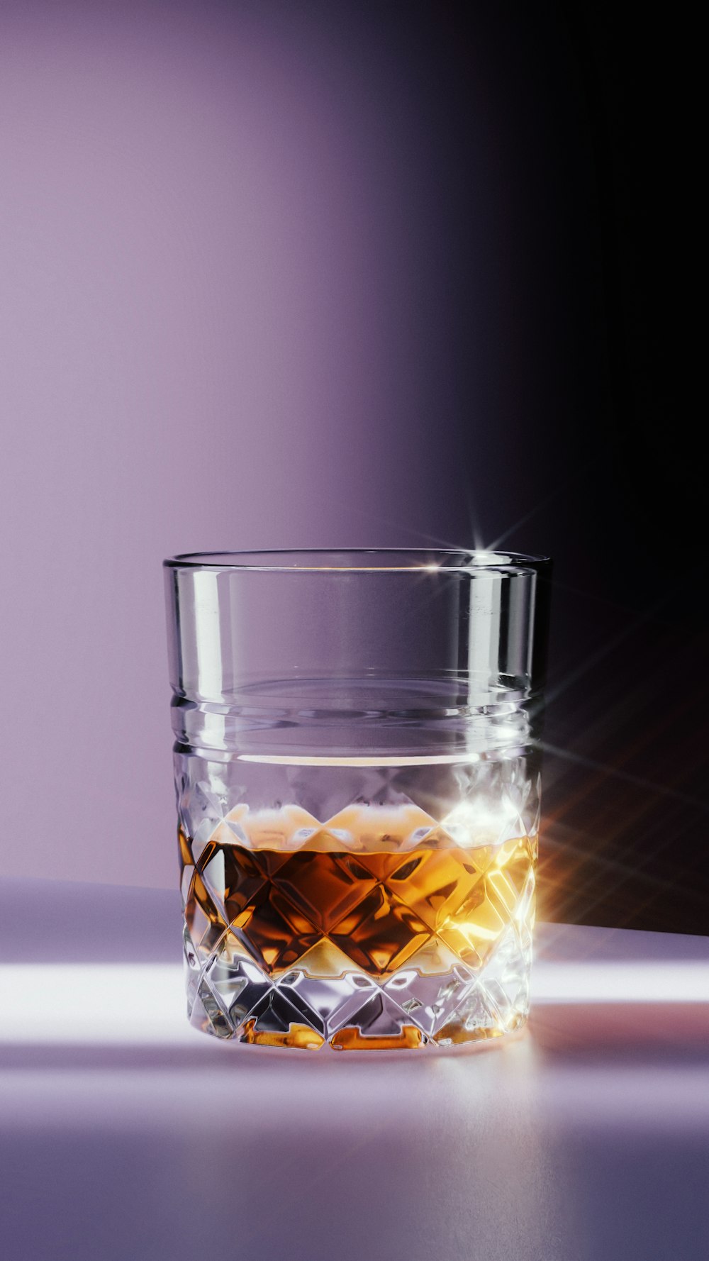 a glass of whiskey sitting on a table
