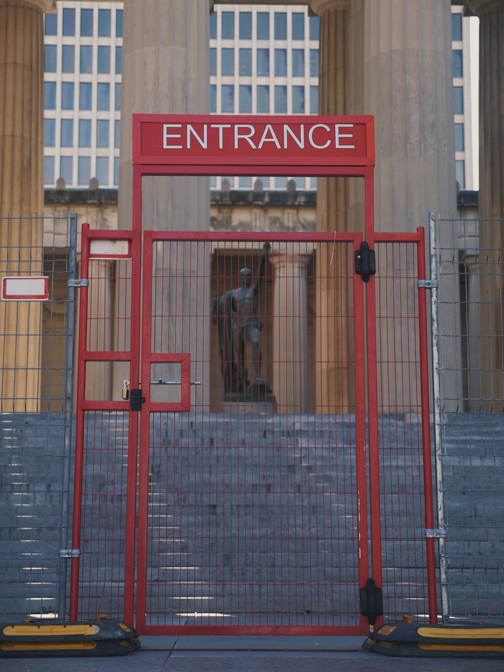 a red gate with a sign that reads entrance