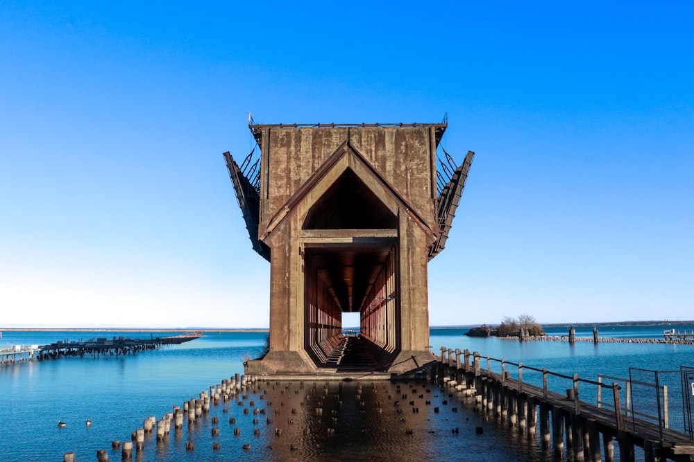a wooden structure sitting on top of a body of water