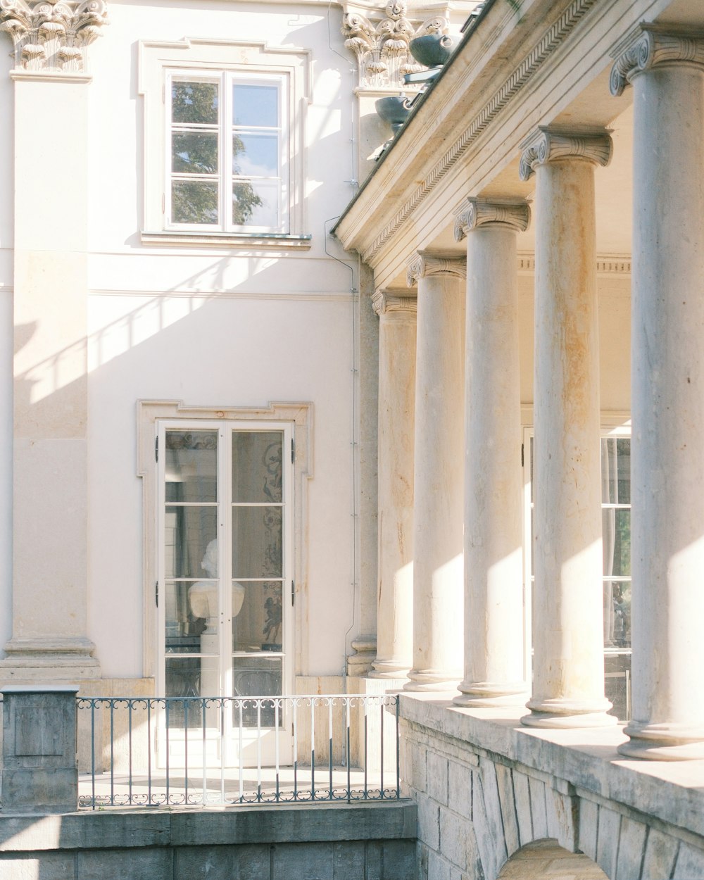 a large white building with columns and a clock