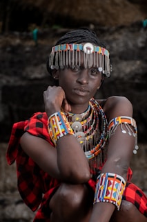 a woman in a colorful headdress and bracelets