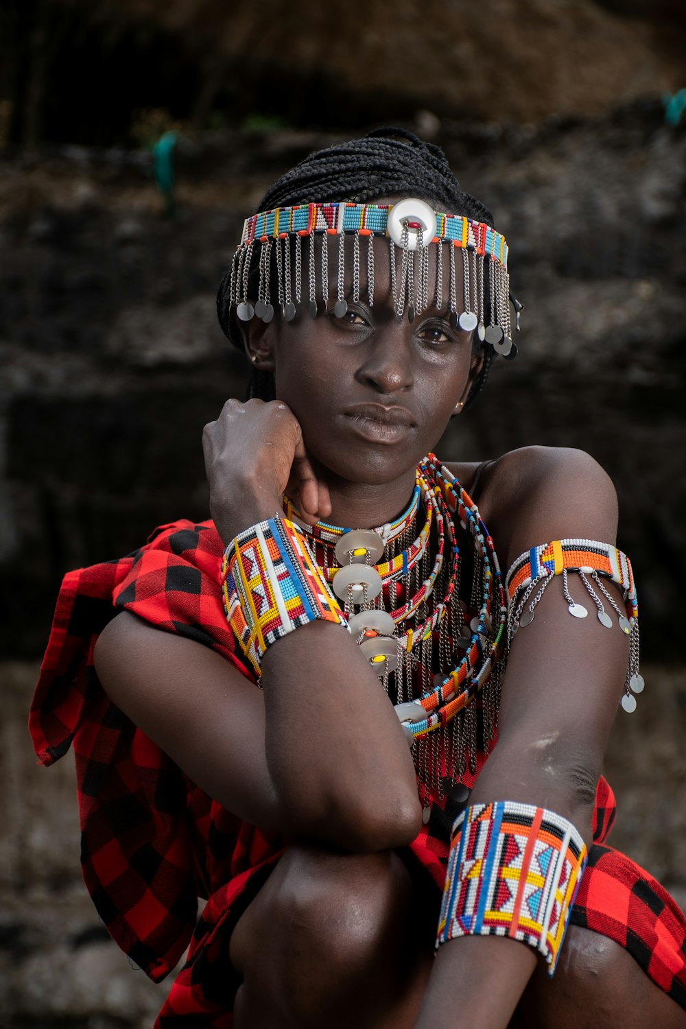 a woman in a colorful headdress and bracelets