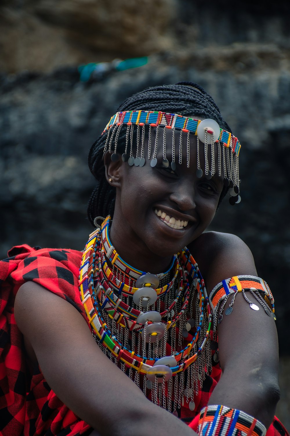 a woman in a colorful dress smiles for the camera