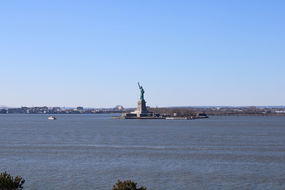 a large body of water with a statue of liberty in the middle