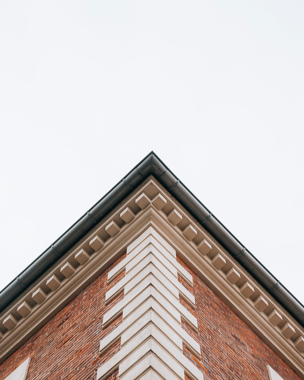 a tall brick building with a clock on it's side