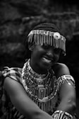 a woman wearing a headdress and smiling for the camera