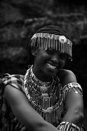 a woman wearing a headdress and smiling for the camera