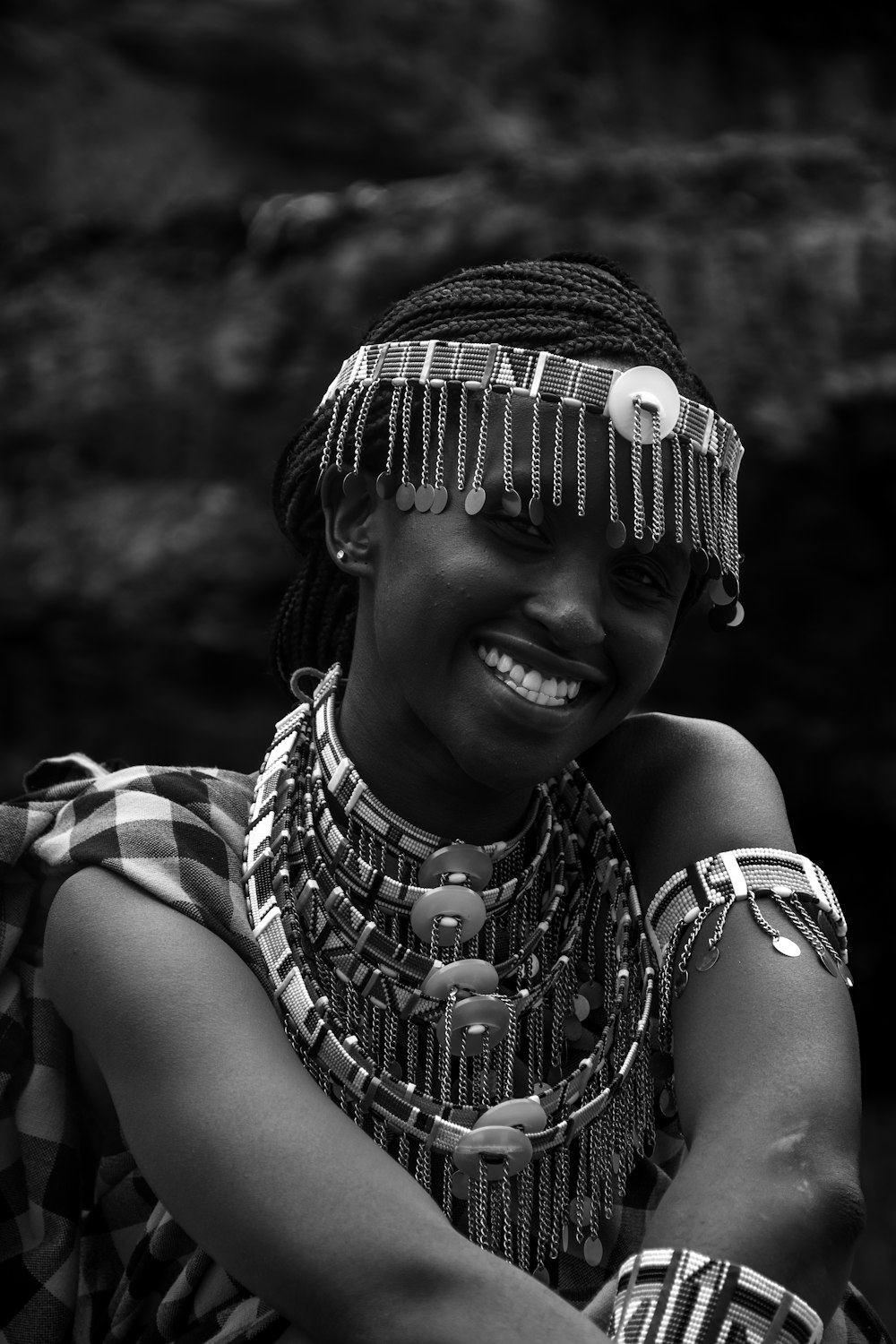 a woman wearing a headdress and smiling for the camera