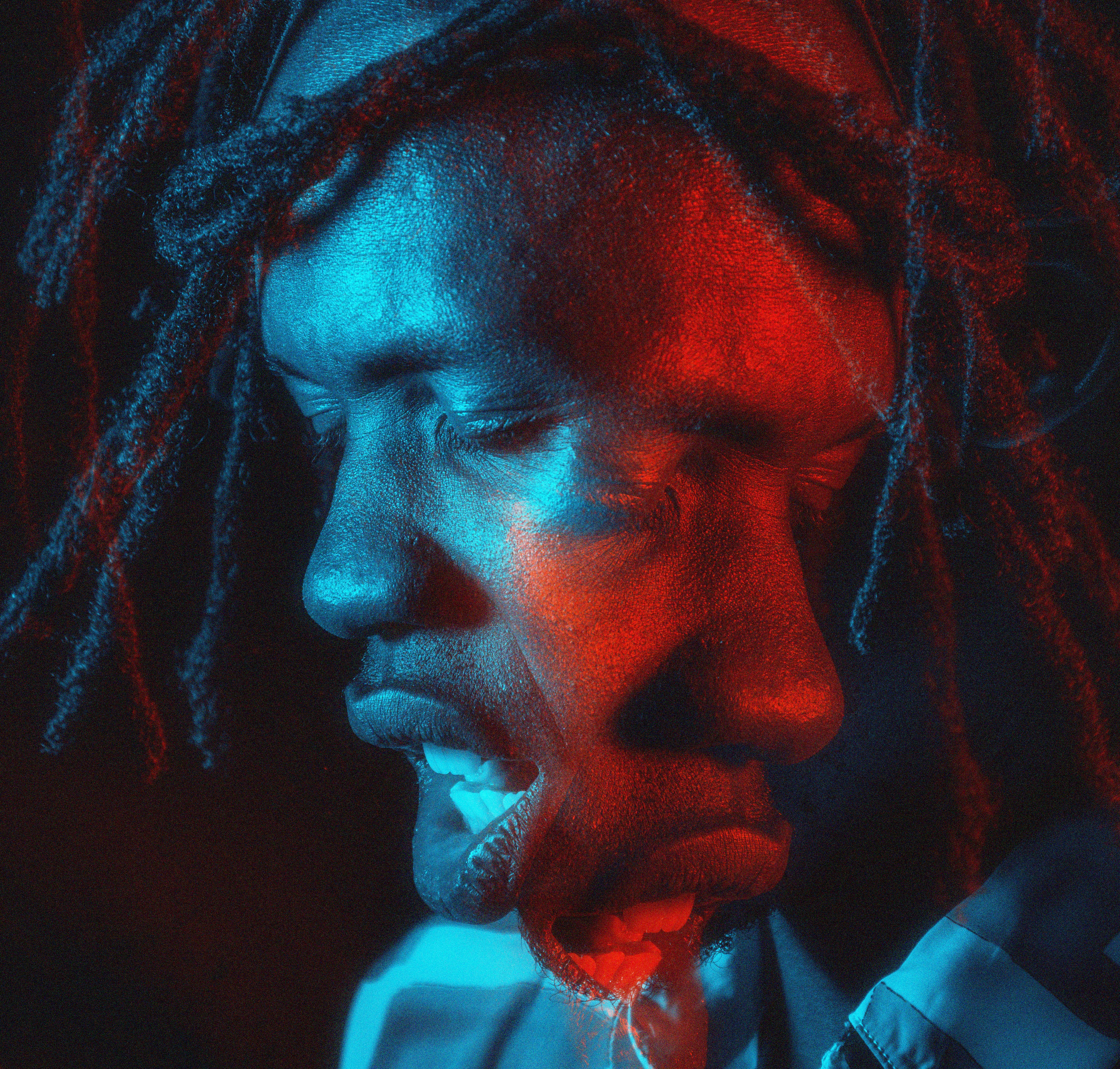 ein Mann mit Dreadlocks und blauem Hemd