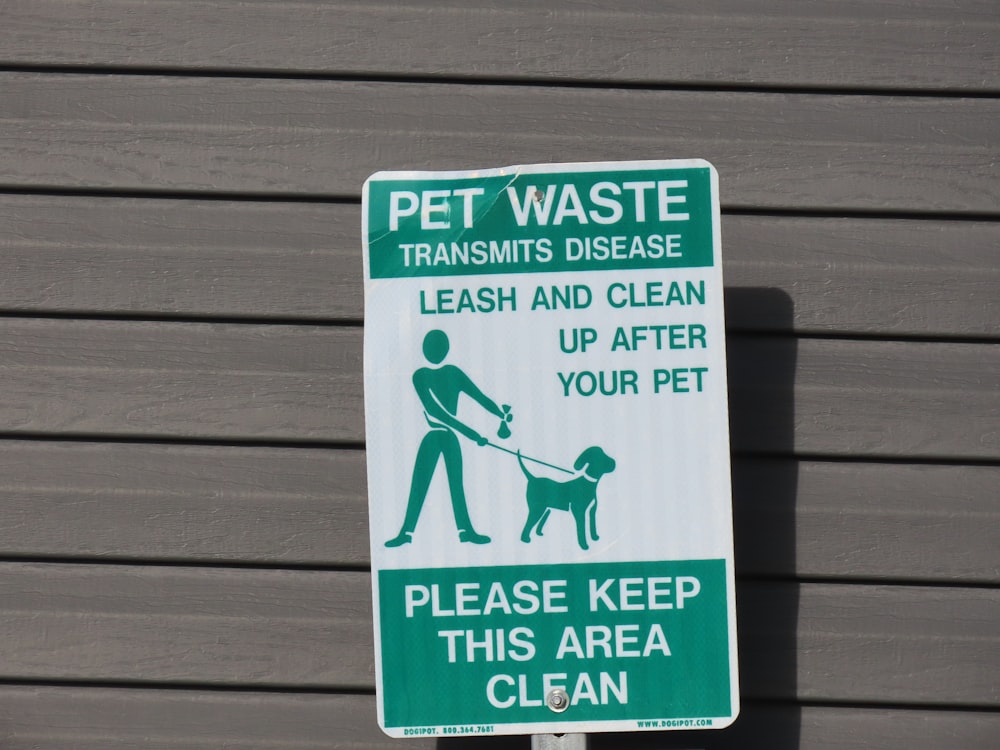 a green and white sign with a dog on it