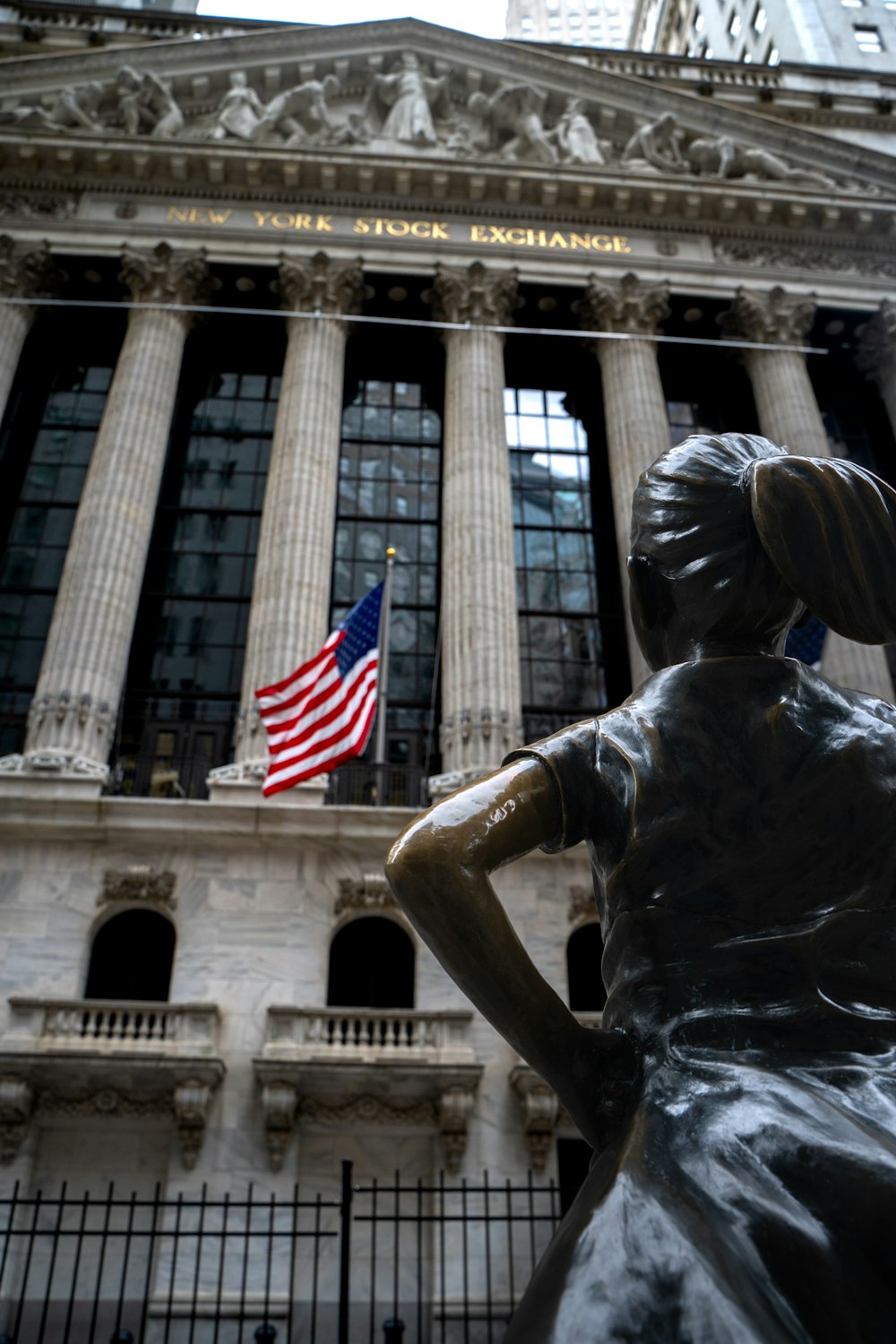 a statue of a woman in front of a building