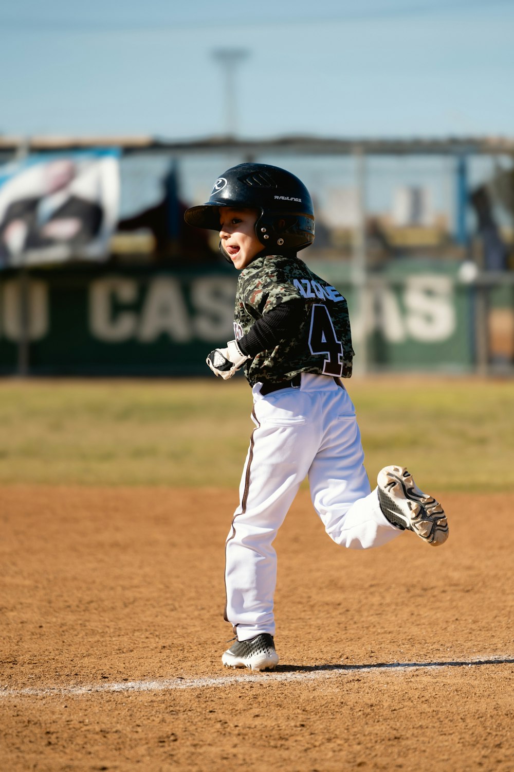 a young boy running to first base during a baseball game