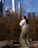 a woman standing on a rock near a body of water